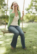 Woman Using Cellphone on a Swing