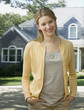 Woman Smiling at Camera Outside of Her Home