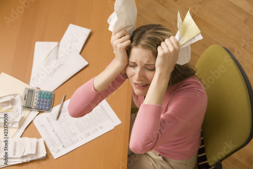 Photo: Woman Paying Bills Woman Paying Bills