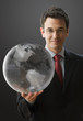 Smiling Businessman Holding a Globe