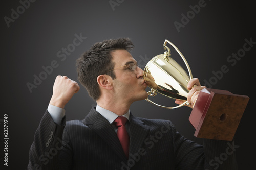 Photo: Businessman Kissing Trophy Businessman Kissing Trophy