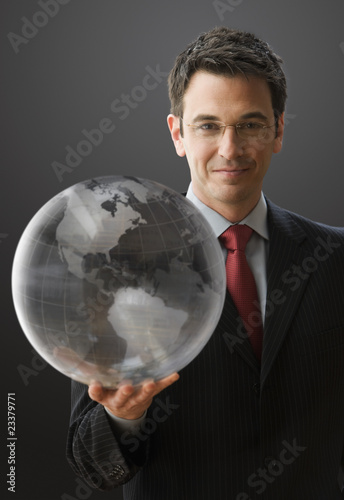 Foto: Smiling Businessman Holding a Globe Smiling Businessman Holding a Globe