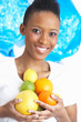 Young Woman Holding Citrus Fruit In Studio