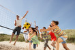 Group Of Teenage Friends Playing Volleyball On Beach