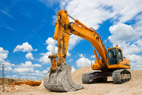 Photo: Yellow Excavator at Construction Site Yellow Excavator at Construction Site