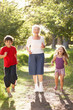 Grandmother Jogging In Park With Grandchildren