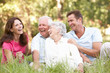 Senior Couple With Grown Up Children In Park