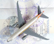 Toy plane on passport depicting travel