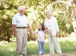 Grandparents In Park With Granddaughter
