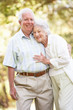 Photo: Senior Couple Walking In Park Senior Couple Walking In Park