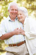 Senior Couple Walking In Park