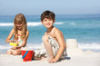 Photo: Children Building Sandcastles On Beach Holiday Children Building Sandcastles On Beach Holiday