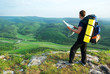 Man tourist in mountain read the map.