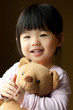 Smiling little child with a teddy bear
