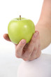 Female hand holding fresh green apple on white background