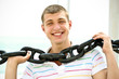 Closeup of happy young guy with enormous chain