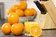 Glass of orange juice and oranges