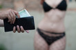 Man is paying for sex in euro banknotes