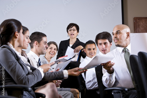 Photo: Group business presentation handing out papers Group business presentation handing out papers