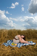 Beautiful slavonic girl on picnic in wheat field
