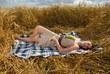 Beautiful slavonic girl on picnic in wheat field with grapes