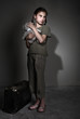 Little lonely girl with suitcase