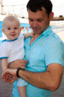 On a platform about a train there is a daddy with the son On a platform about a train there is a daddy with the son