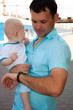 On a platform about a train there is a daddy with the son On a platform about a train there is a daddy with the son