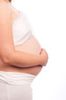 Young Caucasian pregnant woman in white clothes