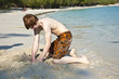 boy is playing at the  beach with sand and building figures