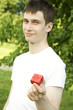 Man's hands gifting heart on holiday day