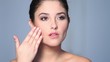 Beautiful young woman applaying cosmetics