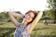 red-haired girl in the village at sunset