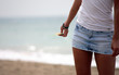 Woman body with sea and beach on background Woman body with sea and beach on background