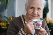 Elderly woman with cup of tea