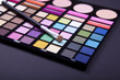 A set of multicoloured eyeshadows with brush