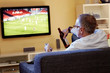 Man with beer watching football