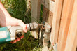 carpenter drill part of wooden with electric bore