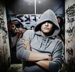 Cool looking hooligan in a graffiti painted gateway Cool looking hooligan in a graffiti painted gateway
