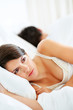 Argument - Upset young couple lying separately on bed