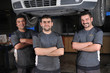 Photo: Three mechanics posing infront of a lifted car Three mechanics posing infront of a lifted car