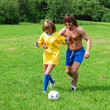 man and young women are plaing with a soccer ball man and young women are plaing with a soccer ball