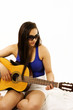 Pretty girl playing guitar, with copy space