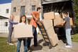 Happy family unloading boxes