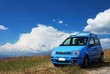 Photo en ligne au meilleur prix Bright pale blue modern car with beautiful nature background