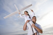 Photo: Hispanic dad playing holding girl high on shoulder Hispanic dad playing holding girl high on shoulder