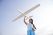 Photo: Pretty girl playing with toy glider Pretty girl playing with toy glider