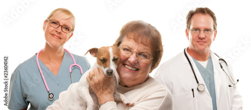 Photo: Happy Senior Woman with Dog and Veterinarian Team Happy Senior Woman with Dog and Veterinarian Team