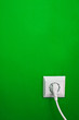 electric outlet on green wall