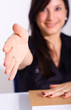 Business woman smiling and doing a handshake in the office